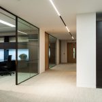 Open plan office corridor with glass partitions and shadow gap ceiling detail at 59 Buckingham Gate, London Victoria