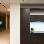 Shadow gap detail in corridor at 59 Buckingham Gate, London Victoria – dark wood panelling with seamless abutment finish