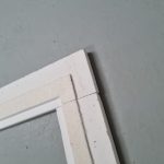 Seamless abutment shadow gap architrave profile – close-up curated installation detail